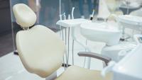 Empty dentist chair and tools in a dental school setting.
